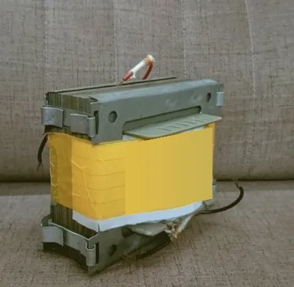 Fabricated E-I laminated-core transformer with yellow-insulated winding and metal mounting brackets.