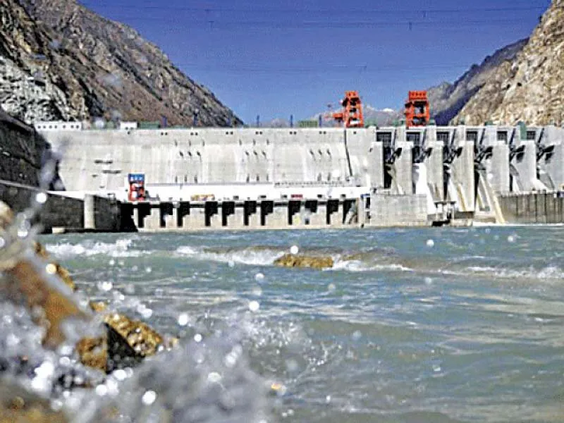 Project-context view of a large dam and surrounding landscape.